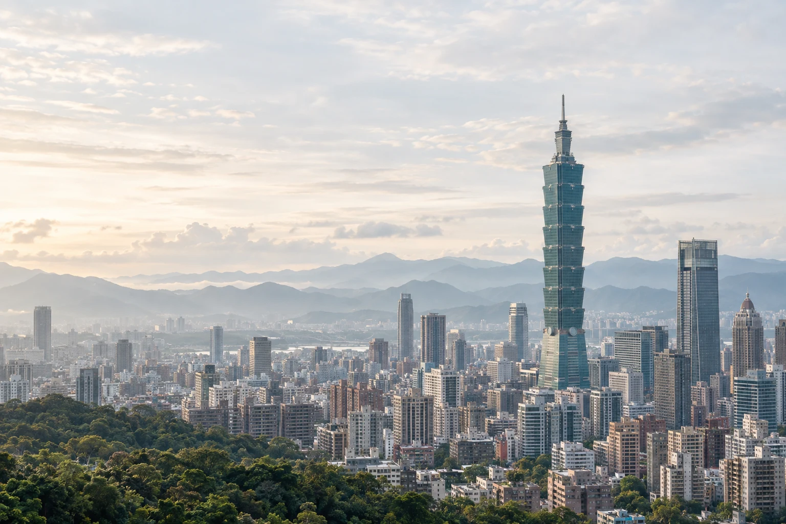 Taipei’s buildings, tree-lined neighborhoods, and mountain horizon in evening light